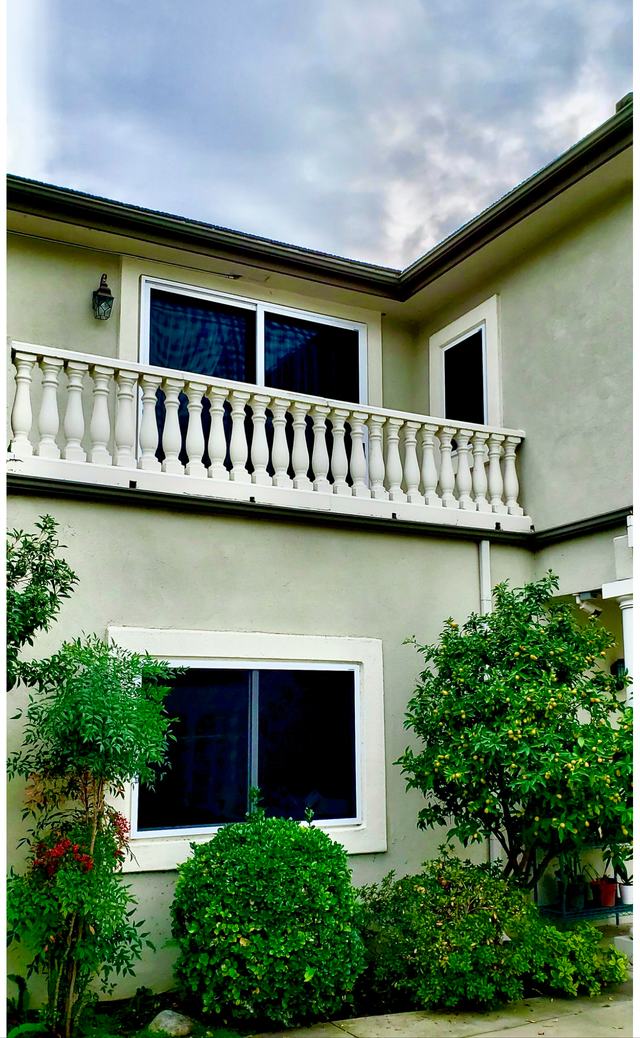 Two-story home with security screens on the upstairs and downstairs sliding windows